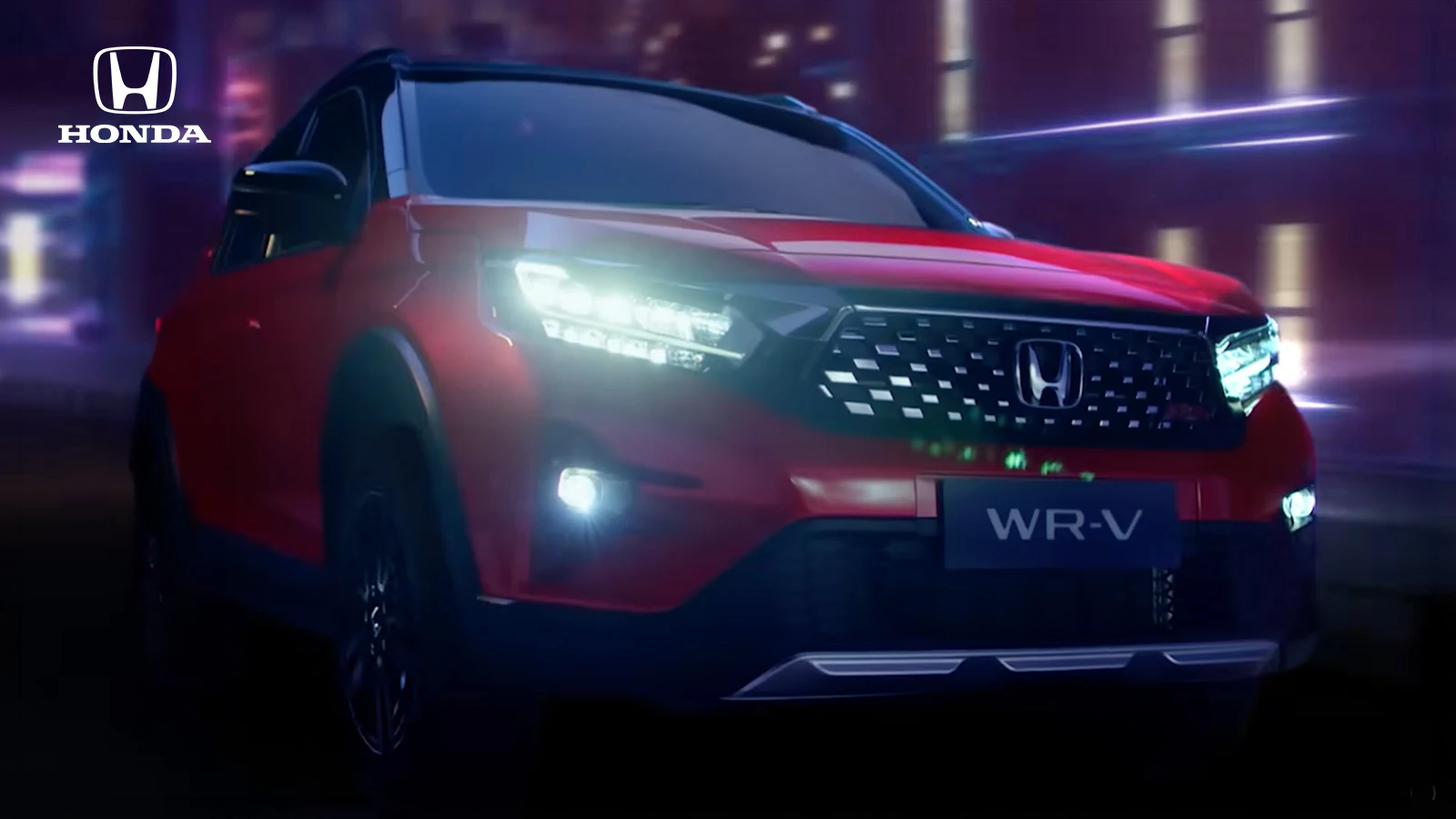 Red Honda WR-V driving through a neon-lit night scene